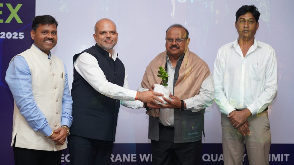 A senior guest being felicitated with a plant and shawl during GeoWeld Connect 2025, presented by the MIPA Industries team.