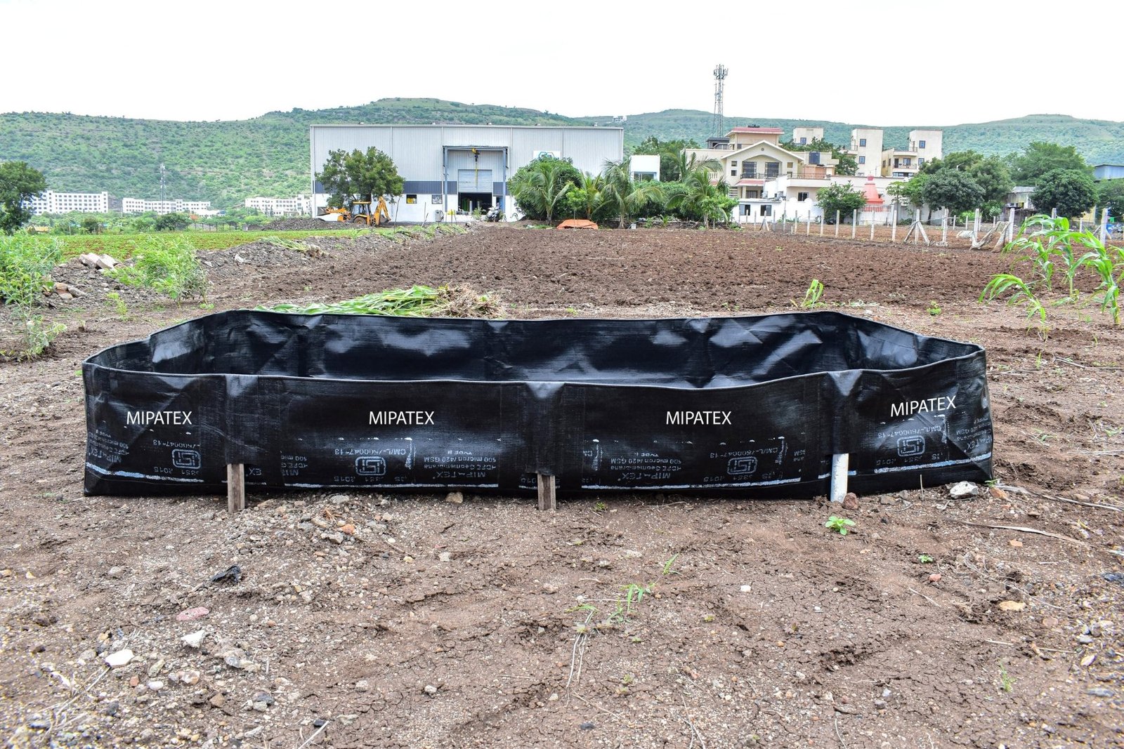 Black MIPATEX Azolla Bed installed on a farm, made from UV-stabilized HDPE laminated fabric for leak-proof Azolla cultivation and water retention.